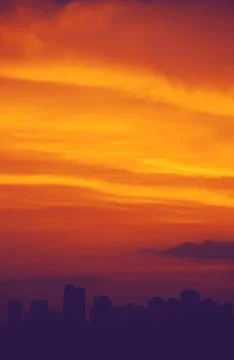 Dramatic sunset over the evening city. Stock Photos