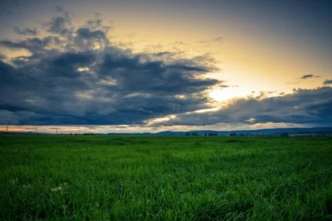 Dramatic sunset over a field. Stock Photos