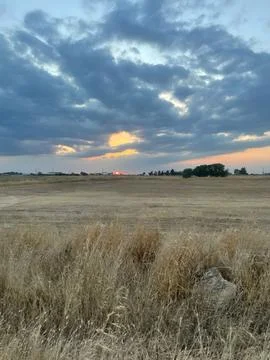 Dramatic Sunset Over Fields in Avgorou, Cyprus  Moody Sky with Thick Clouds.. Stock-Fotos