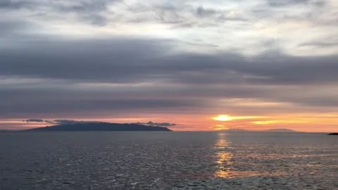 Dramatic sunset over island. Dramatic sky.  Stock Footage 132759436