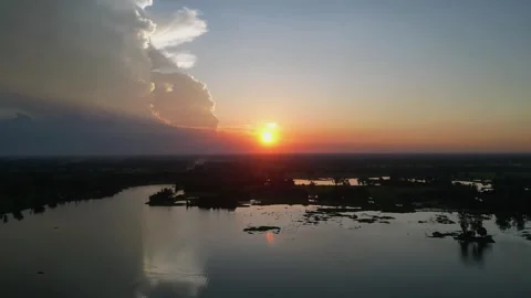Dramatic sunset over lake and countryside with golden sun reflection and la.. Video stock 344694223
