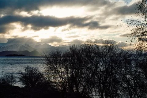 Dramatic sunset over the lake and trees Stock Photos