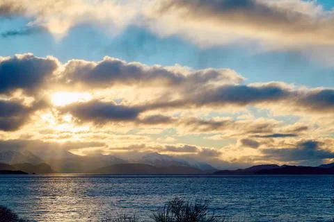 Dramatic sunset over the lake and trees Stock Photos