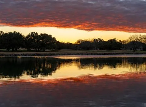 Dramatic sunset over Legacy Hills Park lake and golf course near Georgetown TX Stock Photos