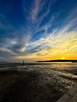 Dramatic Sunset Over Low Tide Coastal Landscape Stock Photos