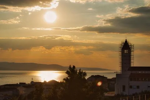 Dramatic sunset over  the Mediterranean sea with a church in the foreground i Stock Photos