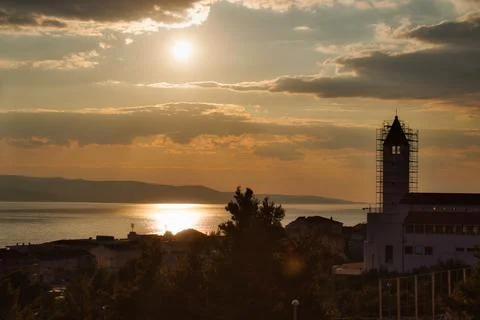 Dramatic sunset over  the Mediterranean sea with a church in the foreground i Stock Photos