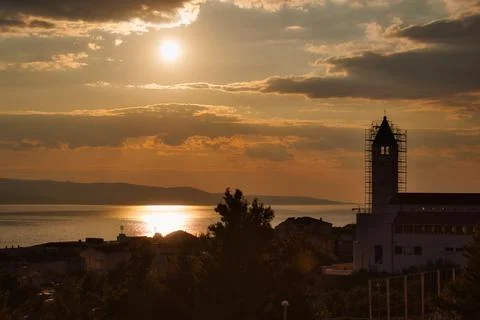 Dramatic sunset over  the Mediterranean sea with a church in the foreground i Stock Photos