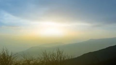 Dramatic sunset over mountain valley in a dense haze Stock Footage 141219070