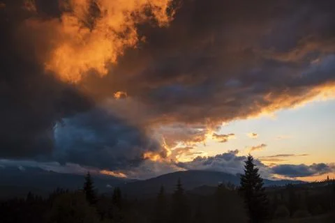 Dramatic Sunset Over Mountainous Landscape Stock Photos