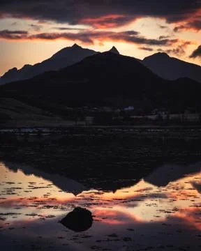 Dramatic sunset over the mountains and the sea of Lofoten islands in Norway - Stock Photos