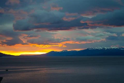 Dramatic sunset over mountains and sea near Ushuaia. Stock Photos