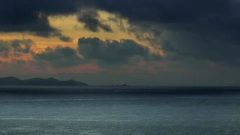 Dramatic sunset over the ocean and mountain silhouette. Video stock 308608668