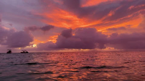 Dramatic sunset over ocean with boats on horizon. Video stock 302369610