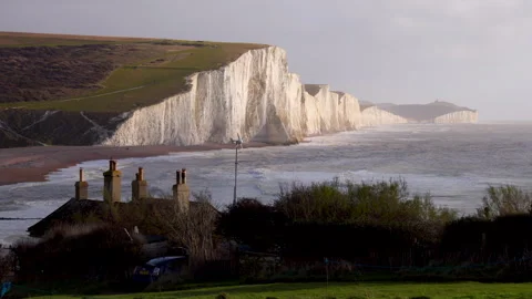 Dramatic Sunset Over Ocean Cliffs with Powerful Waves Stock Footage 265210991