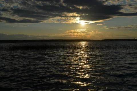 Dramatic sunset over ocean with clouds Stock Photos