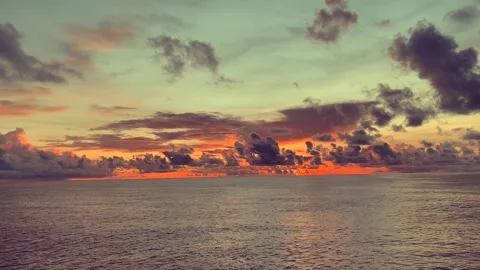 Dramatic sunset over the ocean with colorful clouds reflecting on the water.. Stock Footage 338280346