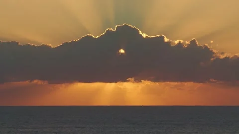 Dramatic Sunset Over Ocean, With Golden Light Bursting Through Dark Stock Footage 336244500