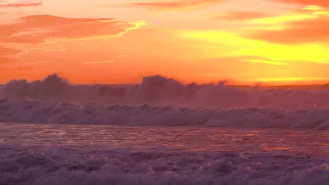 Dramatic sunset over the ocean. Huge waves and bright sky on background Stock Footage 144901932