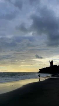 Dramatic Sunset Over Ocean Shore with Person Silhouette in Bali Stock Photos