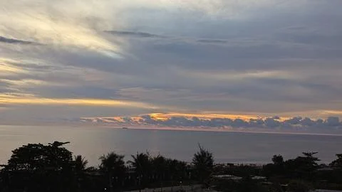 Dramatic Sunset Over the Ocean with Silhouetted Trees 3 Photos