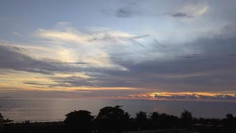 Dramatic Sunset Over the Ocean with Silhouetted Trees 4 Photos