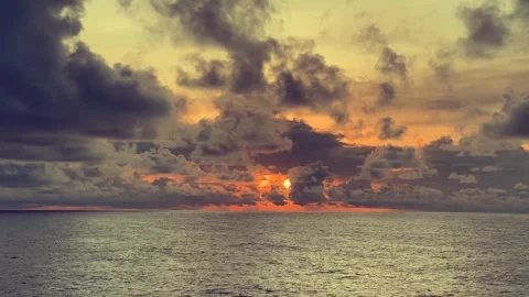 Dramatic sunset over the ocean with vibrant clouds filling the sky and warm.. Stock Footage 338281661