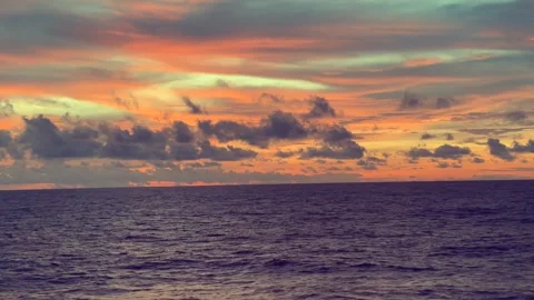 Dramatic sunset over the ocean with vibrant orange and blue skies accompani.. Stock Footage 338281714