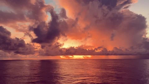 Dramatic sunset over the ocean with vibrant orange and purple clouds reflec.. Stock Footage 338282216