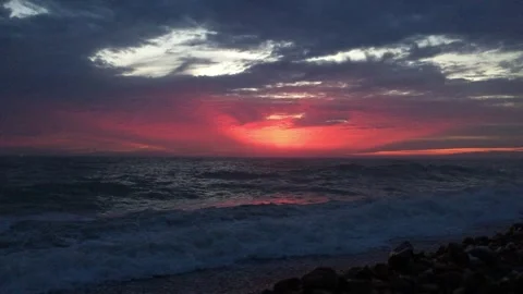 Dramatic sunset over the ocean with waves crashing Stock Footage 336443265
