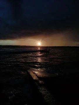 Dramatic sunset over ocean waves Stock Photos