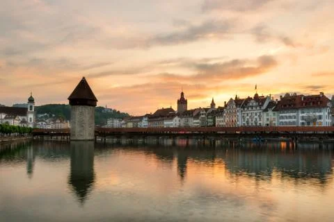 Dramatic sunset over the old town of Lucerne, Chapel Bridge and Water tower i Stock Photos