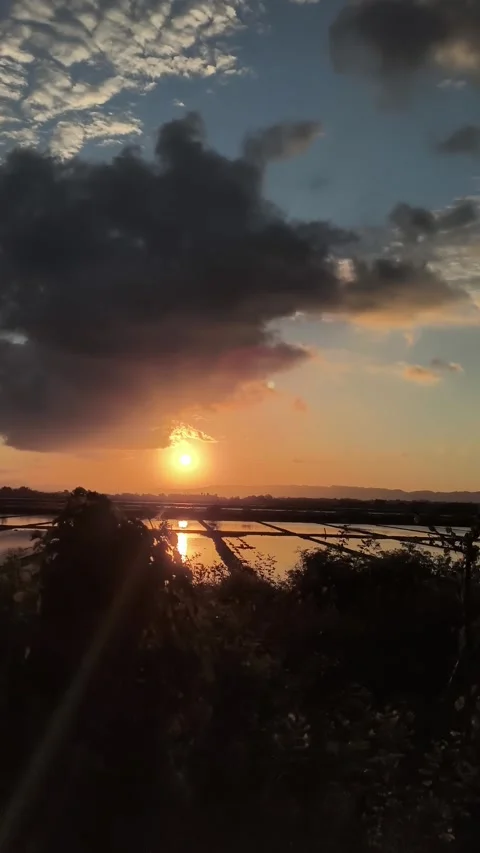 Dramatic Sunset Over Reflective Rice Fields and Rural Landscape Stock-Footage 340420207