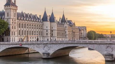 Dramatic sunset over river Seine and Conciergerie timelapse in Paris, France Stock Photos