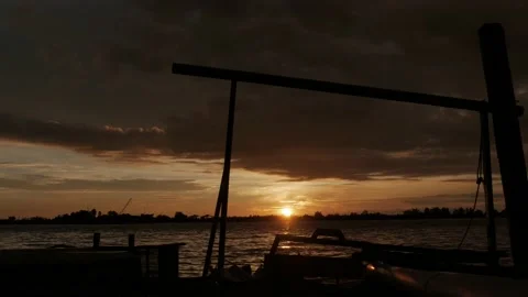 Dramatic sunset over the river on water processing station of rubber factory Stock Footage 143563334