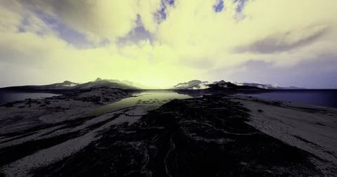 Dramatic sunset over rocky coastline and tranquil waters near mountains Stock Illustration