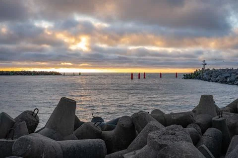 Dramatic sunset over rocky coastline Stock Photos