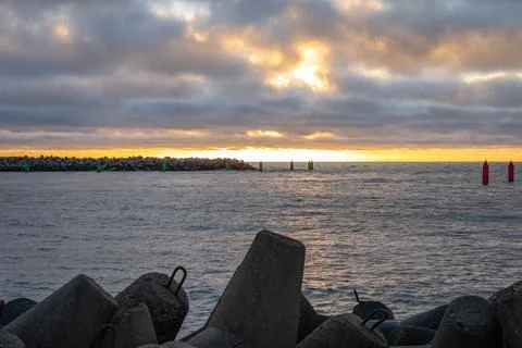 Dramatic sunset over rocky coastline Stock Photos