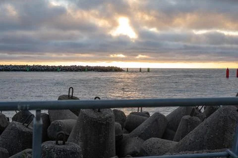 Dramatic sunset over rocky coastline Stock Photos