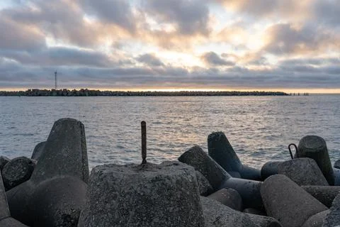 Dramatic sunset over rocky coastline Stock Photos