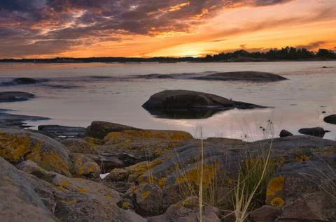 Dramatic Sunset Over Rocky Skerry Coast by Calm Sea. In Sweden, Darvik. Stock Photos