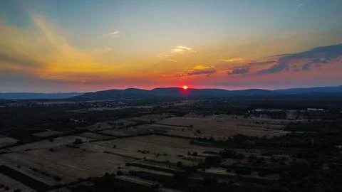 Dramatic sunset over rolling farmland and hills in the Croatian or European Stock Photos