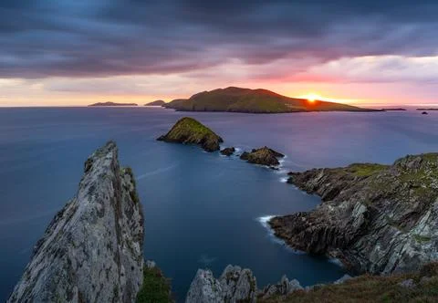 A dramatic sunset over the rugged coastline of Dunmore Head Stock Photos
