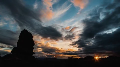 Dramatic Sunset Over Rugged Rock Formation in HD Stock Footage 323835482