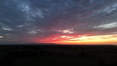Dramatic Sunset Over Rural Landscape Beneath Colorful Evening Sky Stock Footage 337851247