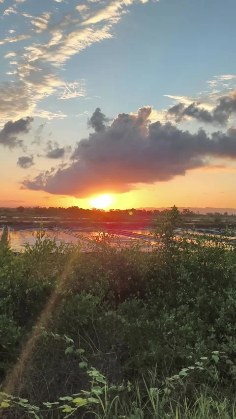 Dramatic Sunset Over Salt Pans With Golden Sky Reflections Stock Footage 340420239