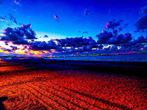 Dramatic Sunset Over Sandy Beach and Cityscape in Mohammedia, Morocco Stock Photos