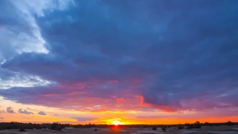 Dramatic sunset over the sandy prairie, dark cloudy sky, time lapse scene Stock Footage 117169718