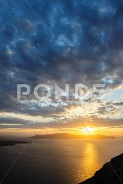 Dramatic sunset over Santorini caldera sea Stock Photos
