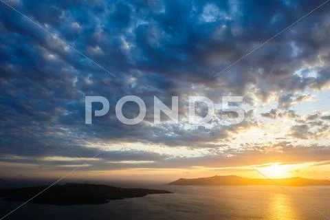 Dramatic sunset over Santorini caldera sea Stock Photos